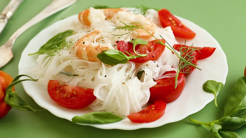 delicious seafood dinner, rice noodles with shrimp and basil