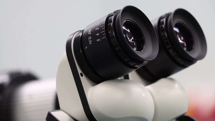 Close up shot of Laboratory microscope lenses hand held shot.