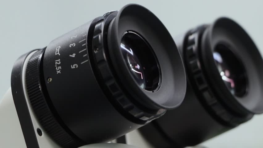 Close up shot of Laboratory microscope lenses hand held shot.