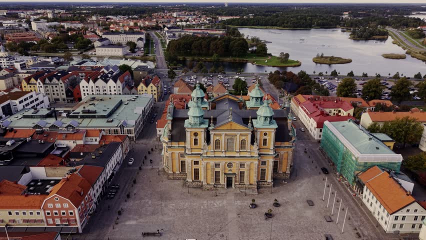 Aerial view of the grand Kalmar Cathedral, its copper domes contrasting with the surrounding red-tiled roofs, Kalmar, Kalmar County, Sweden.