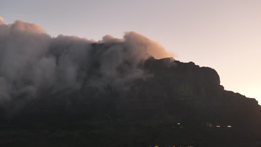 Clouds billowing over Table Mountain, as seen from Cape Town, South Africa
