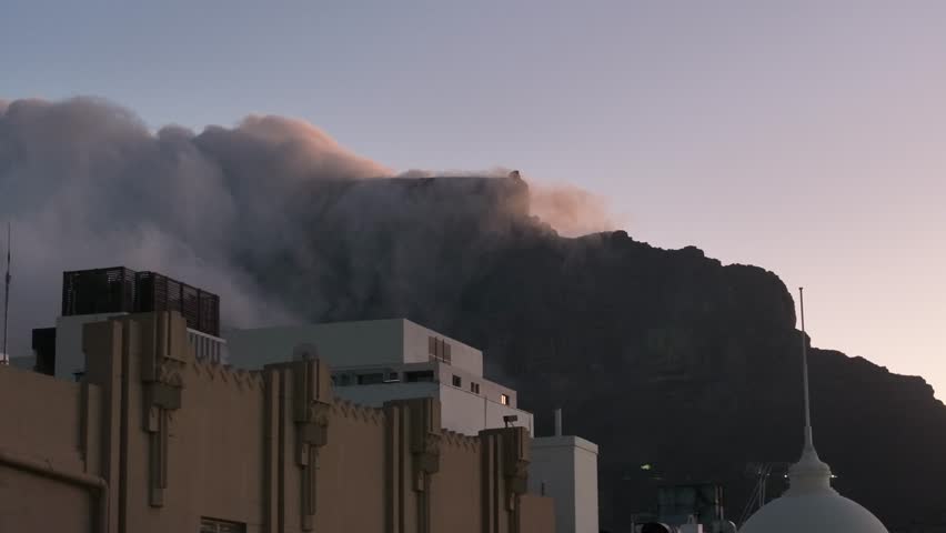 Clouds billowing over Table Mountain, as seen from Cape Town, South Africa