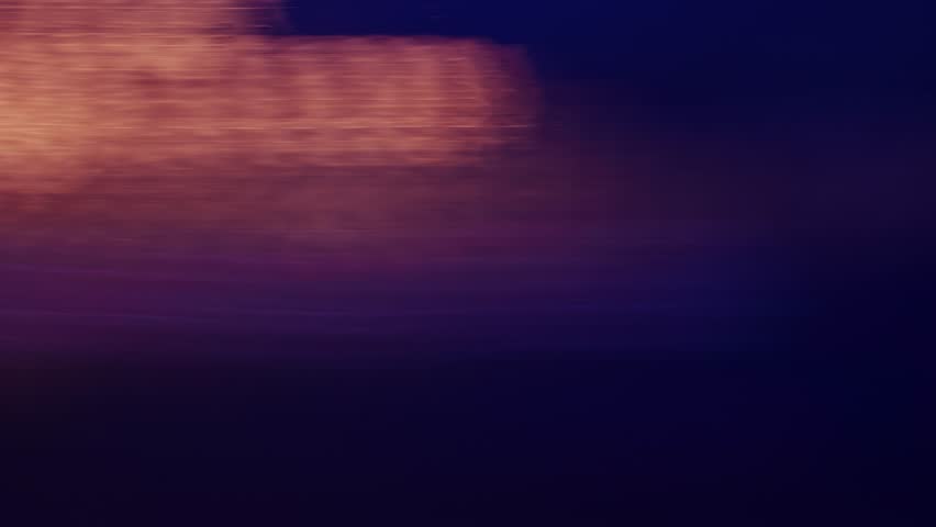 Slow shutter speed footage with motion blur and smeared colorful bokeh circles from street lights at night, abstract dreamy background. 4K, selective focus.