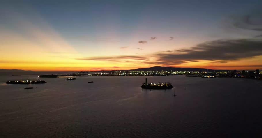 Beautiful aerial drone footage capturing Long Beach Harbor at sunset. Perfect for travel films, documentaries, cinematic projects, and urban landscape visuals.