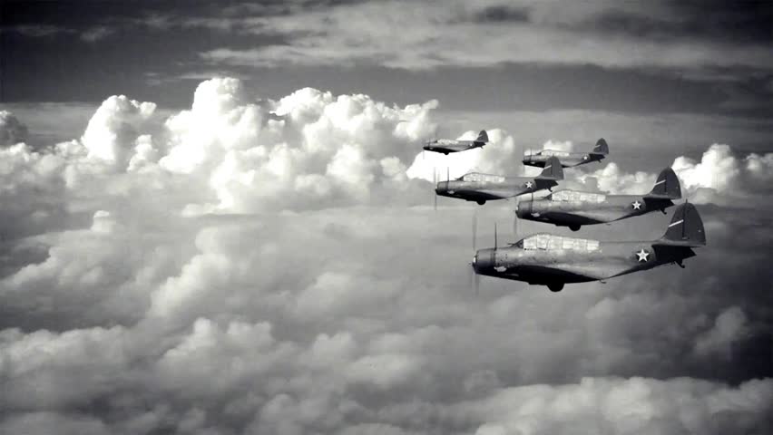 Five fighter airplanes flying in tight formation above clouds, showcasing aerial maneuvers and military aviation in the sky.