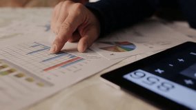 Businessman analyzing investment charts on a tablet, illustrating finance, market analysis, business strategy, and modern digital tools. - Powered by Shutterstock - Get 15% off with code: PIKWIZARD15