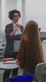 Confident Female Instructor Teaches Coding to Attentive Students, Pointing Lines Code on Interactive Display. Concept Digital Education, IT Learning Environment, Classroom Technology. Vertical Shot. - Powered by Shutterstock - Get 15% off with code: PIKWIZARD15