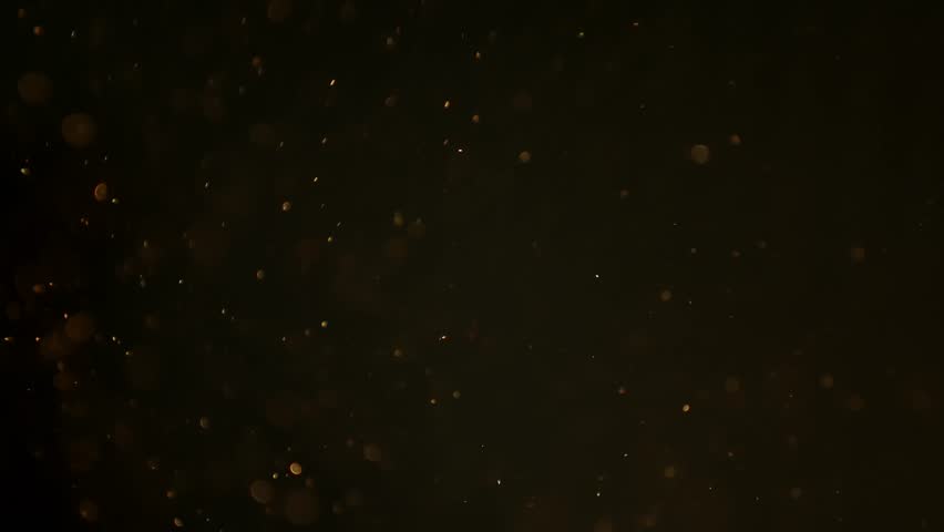 Soft pollen and dust  particles floating in the air, illuminated by warm light beams, creating dreamy abstract bokeh on a dark background. 4K macro footage with gentle motion and selective focus.