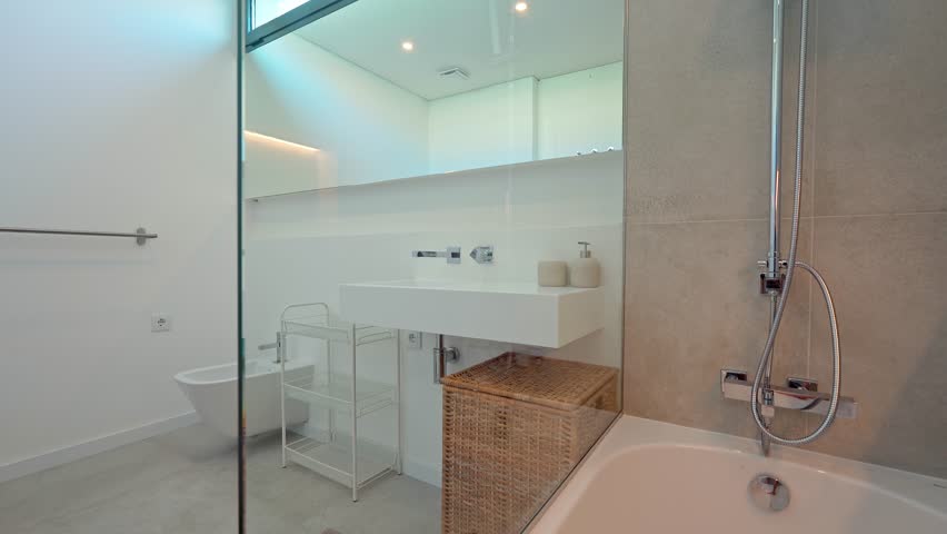 Sophisticated bathroom interior featuring innovative led lighting gradually transitioning colors, highlighting minimalist white design with sleek mirror, spacious shower, and modern sink
