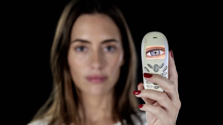 a pretty female with holding different smart phones with eyes on screen 