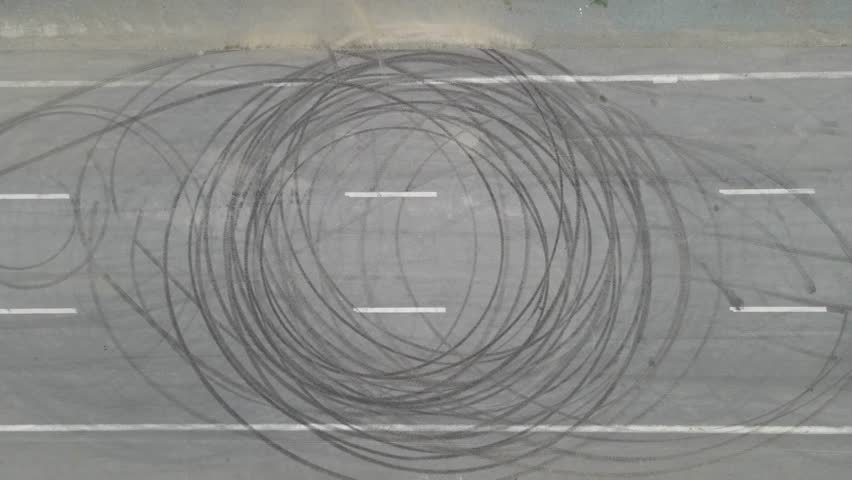 Red Car Drifting and Making Circles on Asphalt