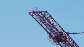 Tower Crane Jib And Trolley Against Blue Sky. Construction Machinery Detail In Sunlight. - Powered by Shutterstock - Get 15% off with code: PIKWIZARD15