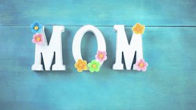 A loving mother places a birthday cake on a purple tablecloth, creating a warm family moment. Perfect for birthday celebrations, family gatherings, and festive lifestyle visuals. - Powered by Shutterstock - Get 15% off with code: PIKWIZARD15