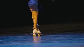 Roller Skater in White Quad Skates Performing on Blue Stage - Powered by Shutterstock - Get 15% off with code: PIKWIZARD15