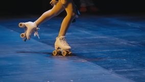 Roller Skater Performing on Blue Stage with White Quad Skates - Powered by Shutterstock - Get 15% off with code: PIKWIZARD15