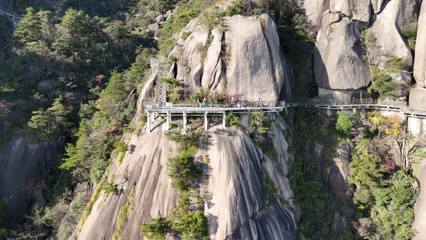Aerial drone footage of Lingshan Mountain in Shangrao, Jiangxi, China, showing misty peaks, Buddhist temples, winding mountain roads, and peaceful natural scenery of a famous travel destination.