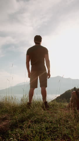 mindful morning in mountains slow motion reveal man meditating at tent sunrise peace