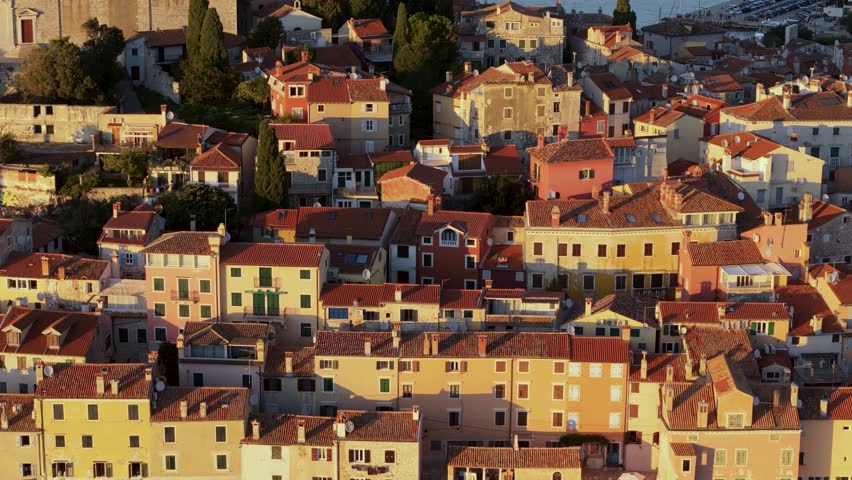 Cinematic Aerial View of Rovinj Old Town, Croatia – Golden Sunset Over Adriatic Sea with Red Rooftops, Historic Architecture and Peaceful Mediterranean Atmosphere. Croatia Aerial View. 