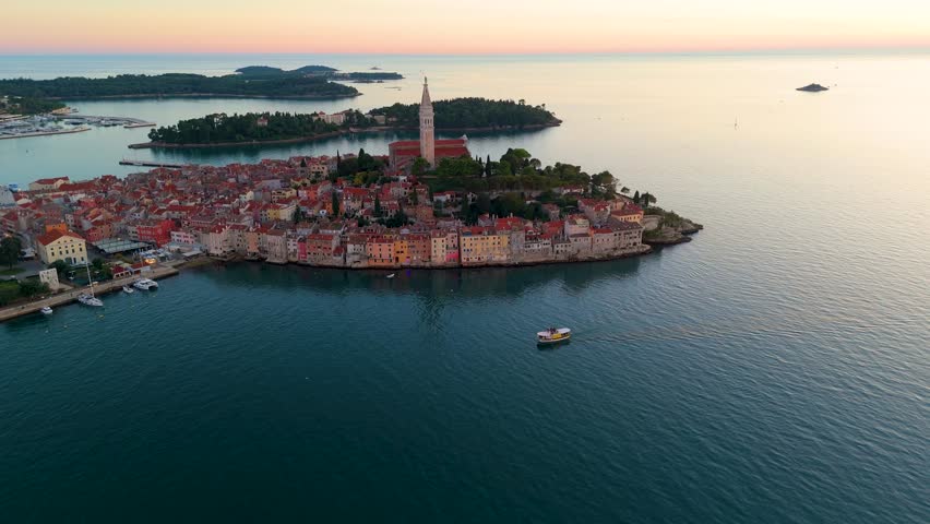 Cinematic Aerial View of Rovinj Old Town, Croatia – Golden Sunset Over Adriatic Sea with Red Rooftops, Historic Architecture and Peaceful Mediterranean Atmosphere. Croatia Aerial View. 