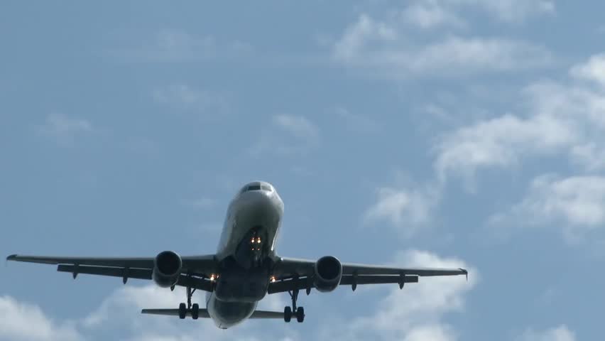 Low-angle view of a jumbo jet airplane flying overhead against the sky, symbolizing air travel, transportation, aviation, and global connectivity. - Powered by Shutterstock - Get 15% off with code: PIKWIZARD15