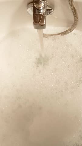 Hot water flowing into a bubble bath