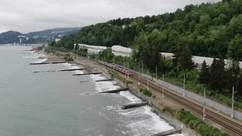 Drone Following Seaside Railway with Passenger Train in Sochi