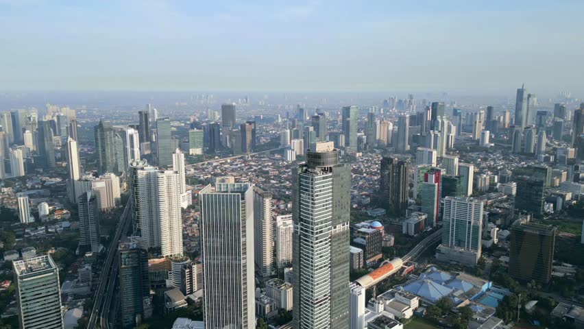 Aerial view of Jakarta, Indonesia with modern skyscrapers, urban skyline, and dense cityscape. Southeast Asia