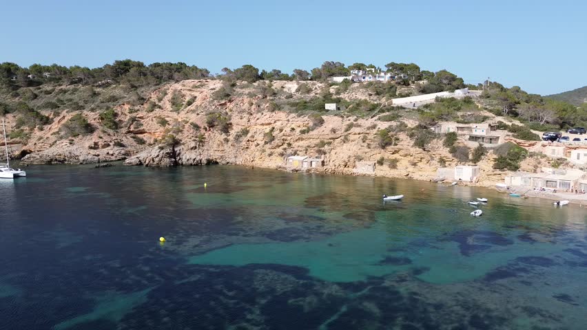 Aerial view of amazing beach with yachts in Ibiza island, Spain. High quality FullHD footage