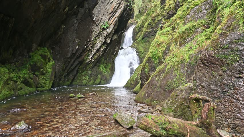 Picturesque summer landscape of Estyuba waterfall falling into Lake Teletskoye. Altai Republic, Russia
