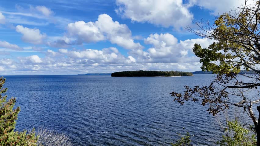 Aerial video of a drone flying from Peninsula State Park toward Horseshoe Island, gliding over Green Bay’s vivid blue waters.