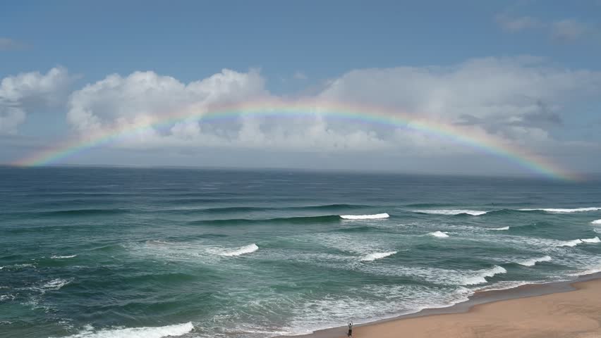 Wide rainbow over the Atlantic Ocean with waves  in Santa Cruz Portugal. 29 October 2025
