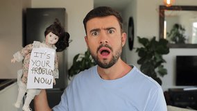 Terrified man holding a porcelain haunted doll  - Powered by Shutterstock - Get 15% off with code: PIKWIZARD15