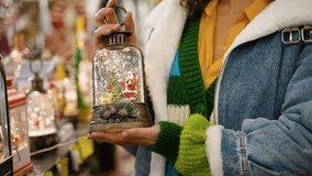 Woman holding Christmas snow globe lantern with Santa Claus - Powered by Shutterstock - Get 15% off with code: PIKWIZARD15