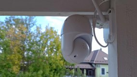 Home security: outdoor surveillance camera adjusting and zooming focus on a tranquil suburban scene - Powered by Shutterstock - Get 15% off with code: PIKWIZARD15