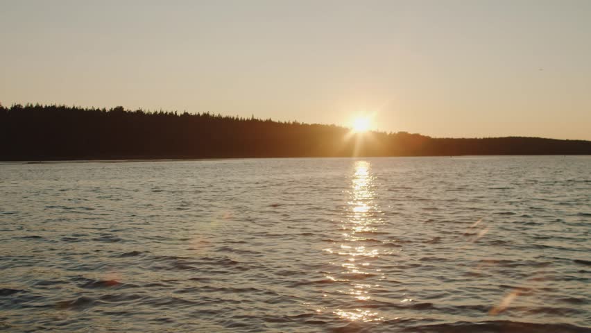 Stunning View Of The Setting Sun Over The Atlantic Ocean In Nova Scotia, Canada, With Warm Golden Light Reflecting On The Waves And Peaceful Coastal Wilderness.