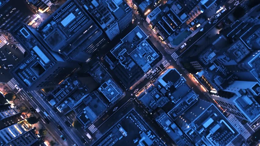A stunning 4K aerial view of the bustling downtown Tokyo cityscape and skyline, capturing illuminated skyscrapers, traffic, and urban life at night.