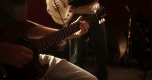 Two skilled musicians energetically playing electric and bass guitars. The focus is on their hands mastering chords and strings during a jam session - Powered by Shutterstock - Get 15% off with code: PIKWIZARD15