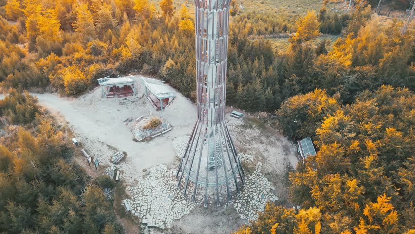Witness the stunning views from Spulka Looking Tower during sunset in Central Bohemia. The tower stands tall amidst beautiful nature, perfect for sightseeing and photography.