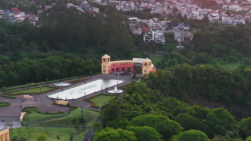 Aerial footage of a public park in downtown Curitiba, Parana, Brazil, showing green areas, walking paths, trees, and surrounding urban buildings.