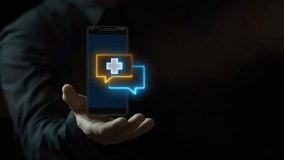 Businessman shows animated smartphone displays chat icons, one with a medical cross. Represents telemedicine, doctor consultation, healthcare communication and remote medical services. - Powered by Shutterstock - Get 15% off with code: PIKWIZARD15