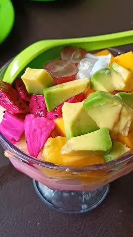 Es campur or mixed ice is an Indonesian fruit cocktail dessert mixed with shaved ice, a mixture of fresh fruit, condensed milk, and syrup.