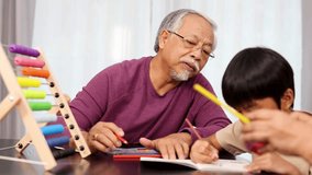 Elderly man and young boy learning with colorful abacus in bright, softly lit living room. - Powered by Shutterstock - Get 15% off with code: PIKWIZARD15