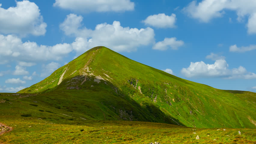 green lonely mount on a dense clouds background, Ukraine, Carpathians, Hoverla mount time lapse scene
