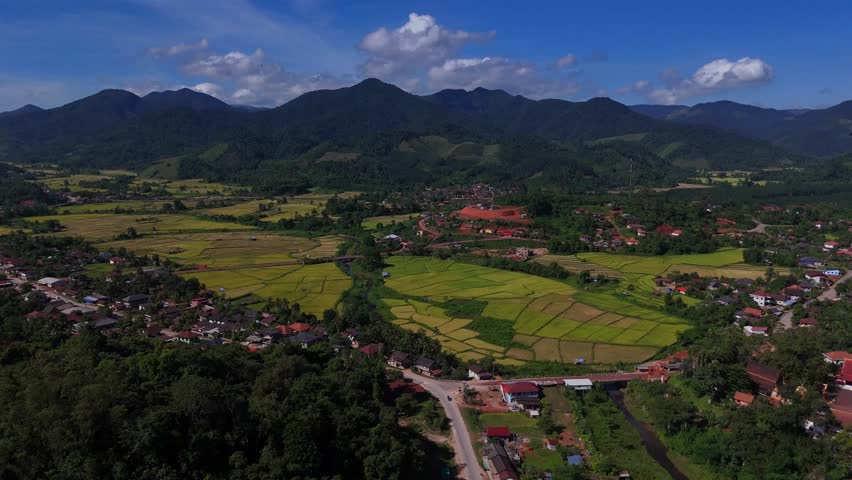 Mountain Valley Landscape: An expansive, vibrant scene of rolling green hills, a serene valley, and distant mountain peaks under a dynamic blue sky.