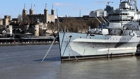 Historic HMS Belfast warship anchored on River Thames in central London between Tower Bridge and Tower of London, symbolizing Britain’s rich naval heritage under clear blue sky. - Powered by Shutterstock - Get 15% off with code: PIKWIZARD15