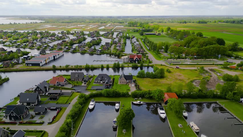 Aerial view of many luxury homes middle of the lakes and canals in The Netherlands countryside.