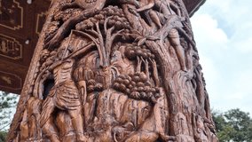 Intricate wood carving showcasing mythological figures and traditional Thai art on a temple pillar - Powered by Shutterstock - Get 15% off with code: PIKWIZARD15