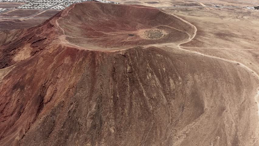 Vibrant Montana Roja volcanic mountain crater with Playa Blanca villa properties below