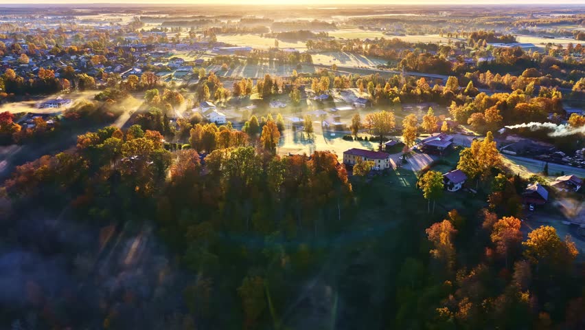 Golden autumn sunrise over Sigulda, Latvia, showcasing vibrant fall colors