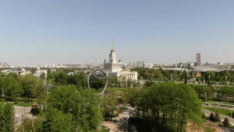Drone Ascending Over Park Towards Exhibition Hall